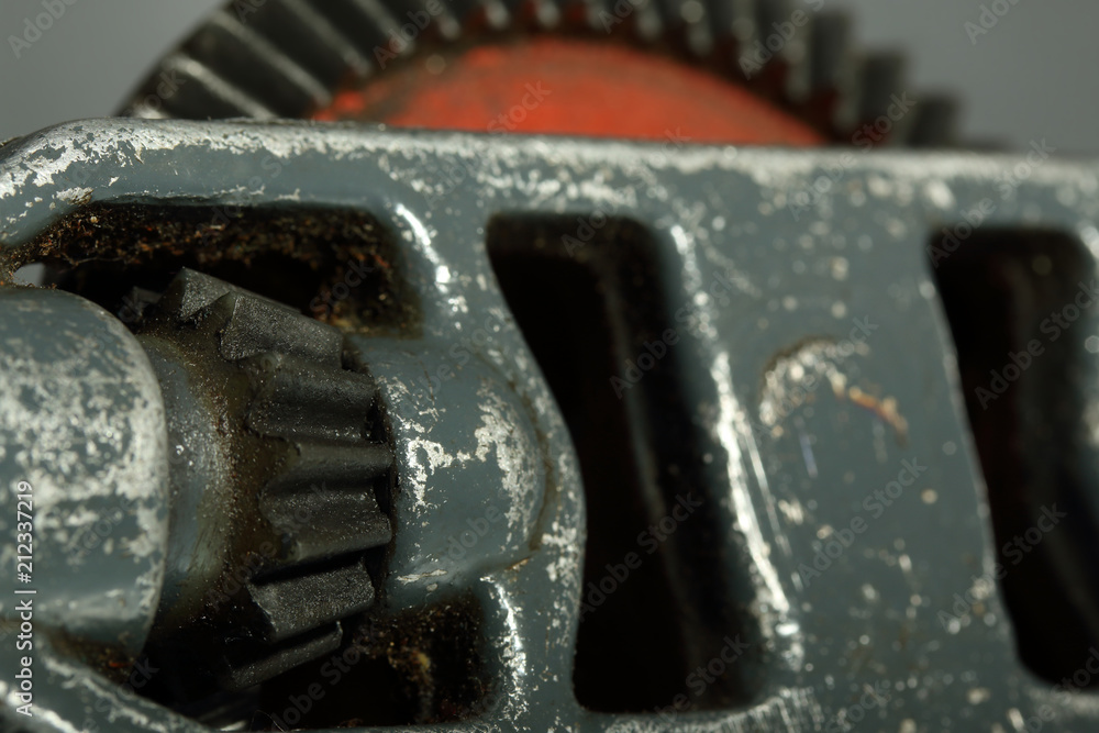 Gears on a gray background. Details of an old hand drill Gears on a gray background. Details of an old hand drill