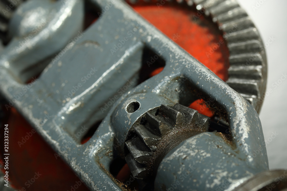 Gears of an old hand drill close-up. Industrial background Gears of an old hand drill close-up. Industrial background