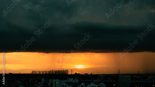 Sunset and Dark rainy cloud. © freezetimetool