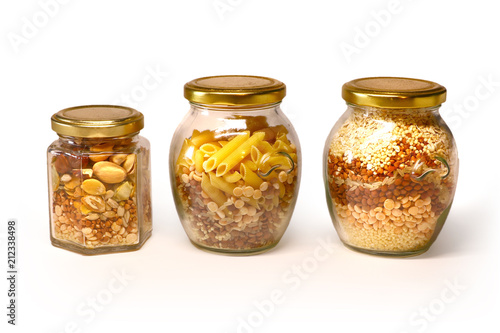 beautiful glass jars with cereal, cereals, pasta on white background