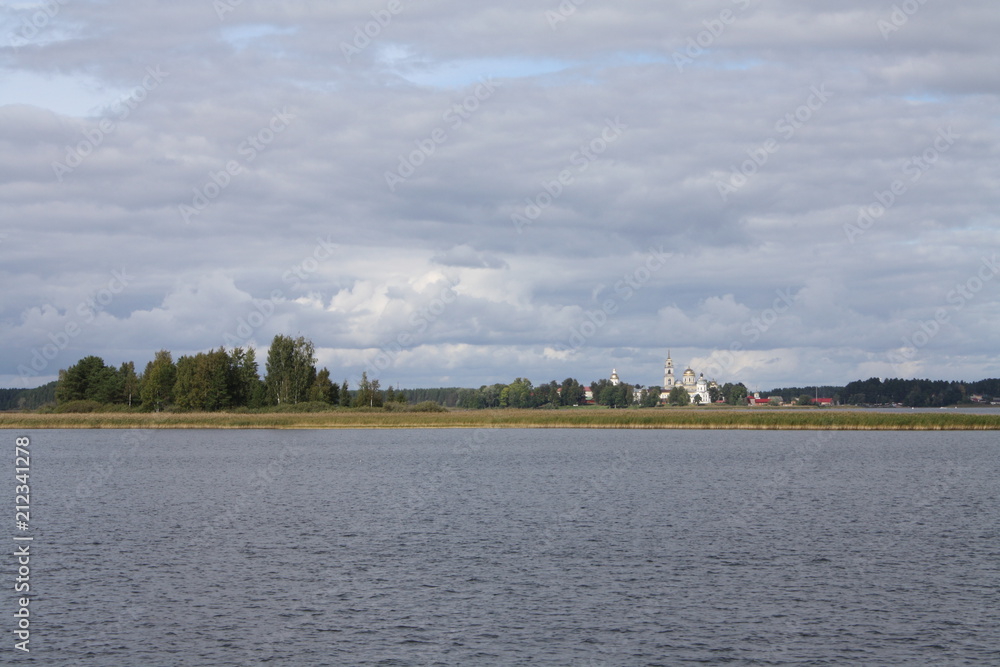 Seliger lake in Russia, Ostashkov, Tver oblast with sky, water, trees and churches in the distance