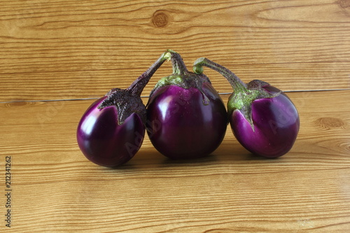 Whole fresh eggplant or aubergine bringal in wooden background