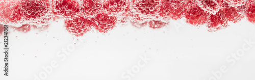 Fresh raspberries in water wiht air bubbles.