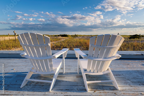 Beach chairs on Cape Cod beach at sunset, Cape Cod, Massachusetts, USA. photo
