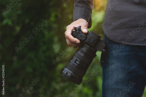 close-up on photographer hand holding camera photo