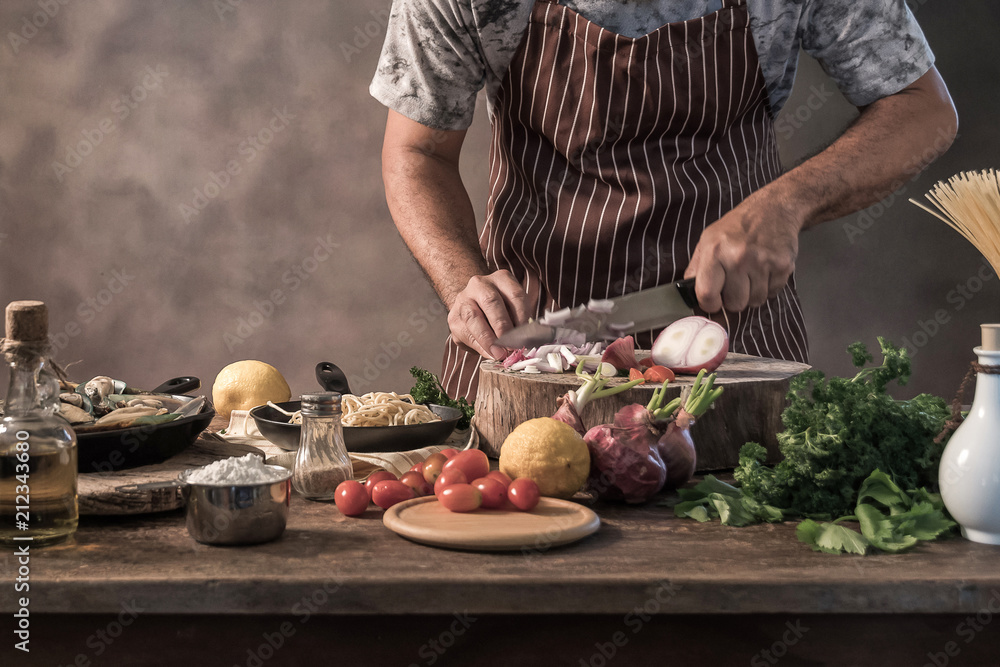 Handsome bearded cheef cook prepairing spaghetti Handsome bearded cheef cook prepairing spaghetti
