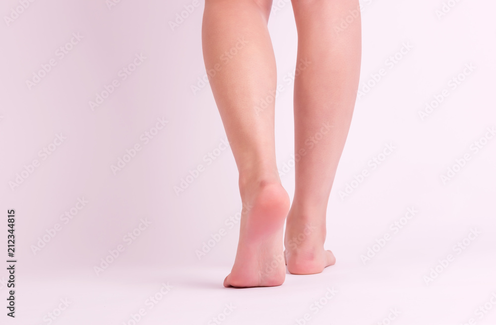 Back view of smooth woman legs and feet walking Back view of smooth woman legs and feet walking