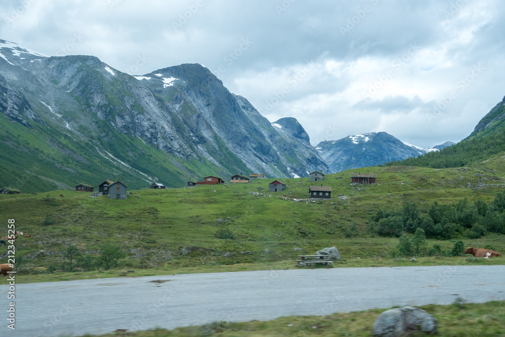 old wood houses in norway wiht beautiful mountain scenery