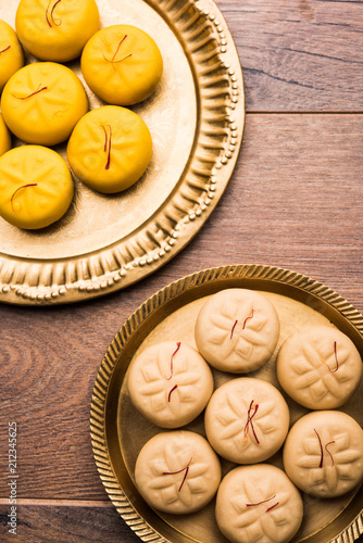 brown and Kesar Pedha or Peda is an Indian traditional sweet dish made from milk khoya and saffron