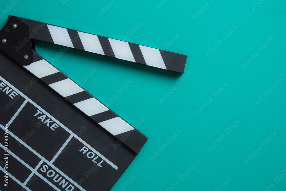 Movie clapper board on blue background,top view