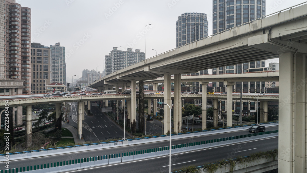 Fototapeta premium Aerial view of highway and overpass in city on a cloudy day