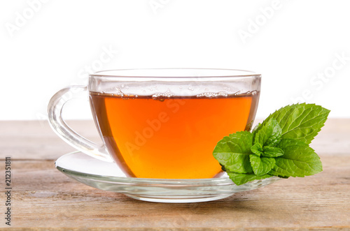 Glass cup of Tea with mint leaves on wooden table