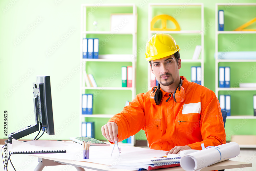 Construction supervisor planning new project in office Construction supervisor planning new project in office