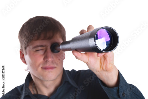 man looking through a telescope