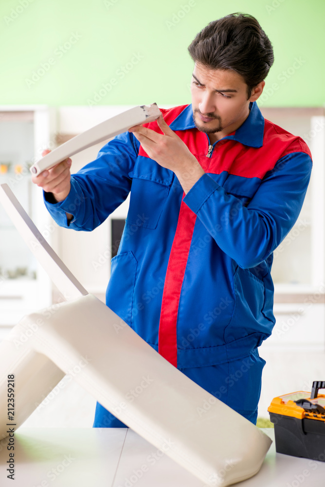 Repair contractor repairing broken chair at home Repair contractor repairing broken chair at home