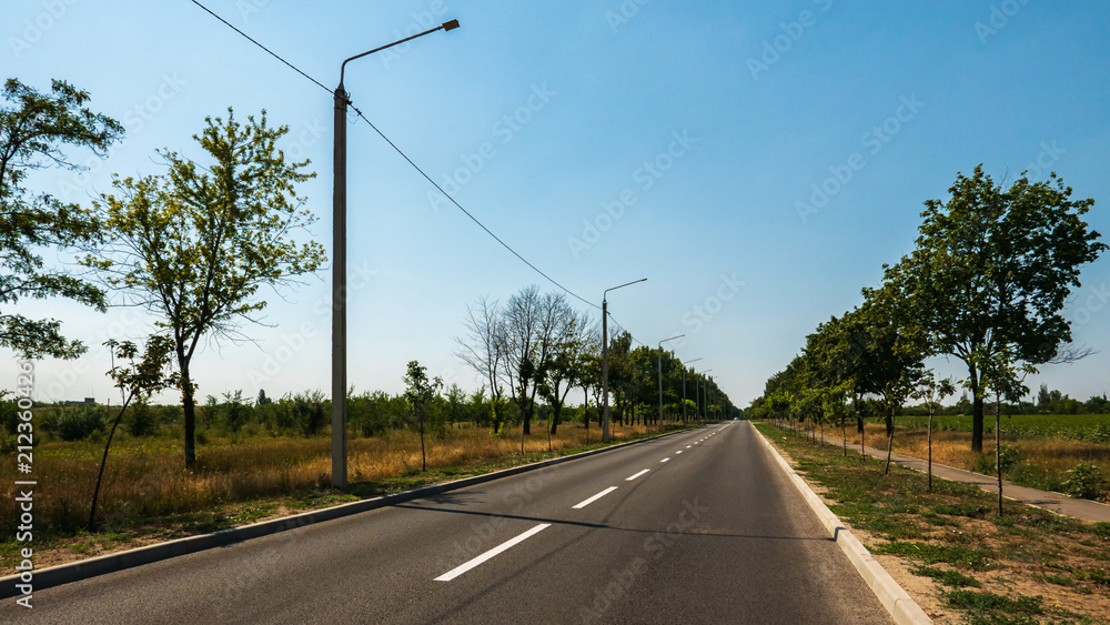 The road with white markings goes to the horizon