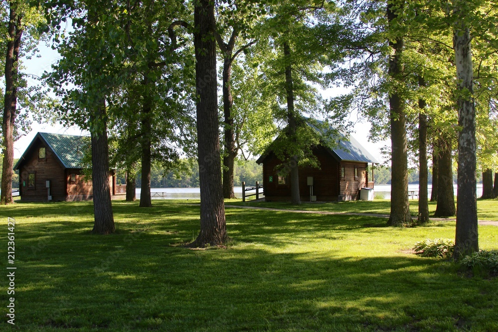 The cabins under the shade trees of the park. 