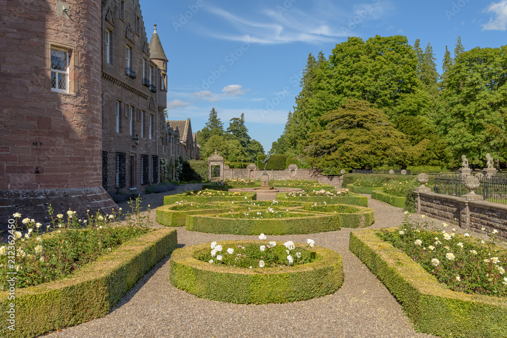 Gardens at Glamis Castle in Scotland. Glamis Castle is situated close to the village of Glamis in Angus. It is the home of the Earl and Countess of Strathmore and Kinghorne, and is open to the public.