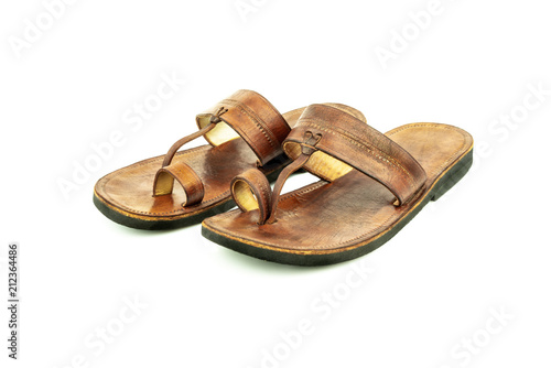 Front view of a pair of brown traditional indian leather sandals isolated on white background.
