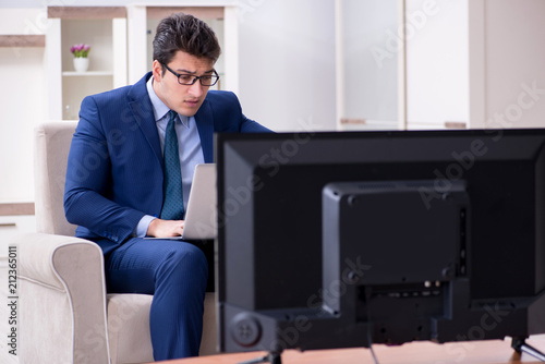 Businessman watching tv in the office