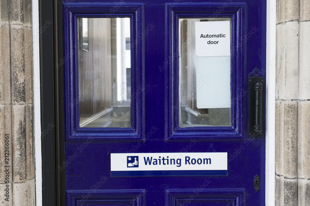 Waiting room sign on blue door at train station Waiting room sign on blue door at train station