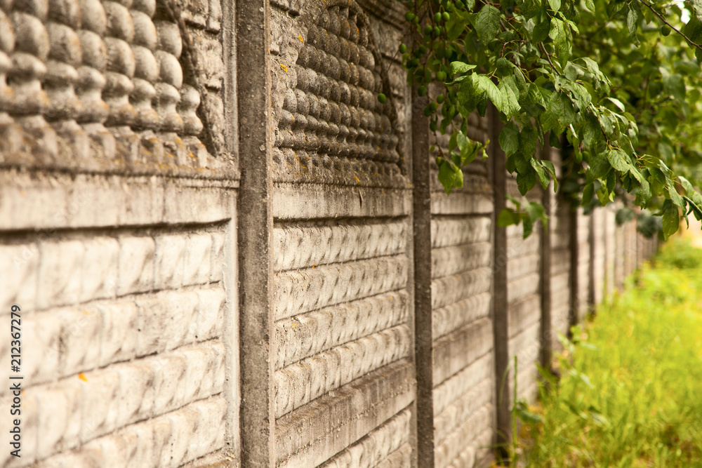 old vintage light stone fence, view along the fence