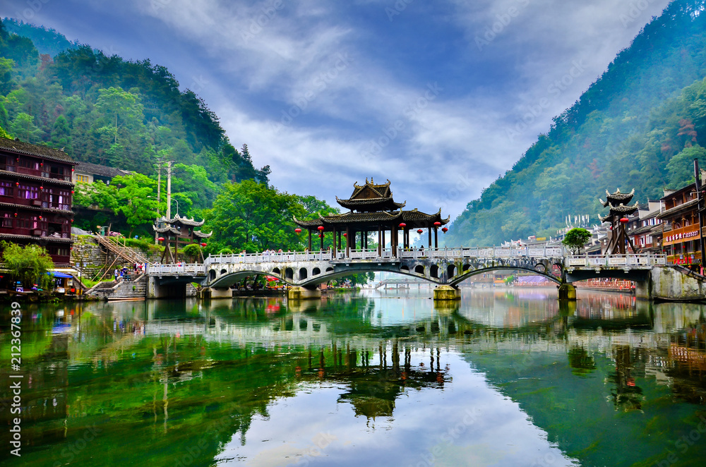 HUNAN, CHINA - JUNE 16, 2014 : Old houses in Fenghuang county in Hunan, China. The ancient town of Fenghuang was added to the UNESCO World Heritage Tentative List in the Cultural category. HUNAN, CHINA - JUNE 16, 2014 : Old houses in Fenghuang county in Hunan, China. The ancient town of Fenghuang was added to the UNESCO World Heritage Tentative List in the Cultural category.