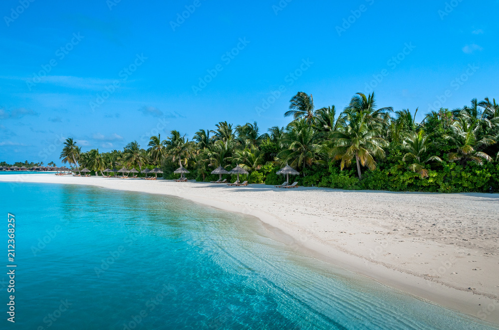 The perfect beach. Beach bungalow. Luxury escape. Tropical paradise. Honeymoon at Maldives. Palms and white sund. Blue ocean The perfect beach. Beach bungalow. Luxury escape. Tropical paradise. Honeymoon at Maldives. Palms and white sund. Blue ocean
