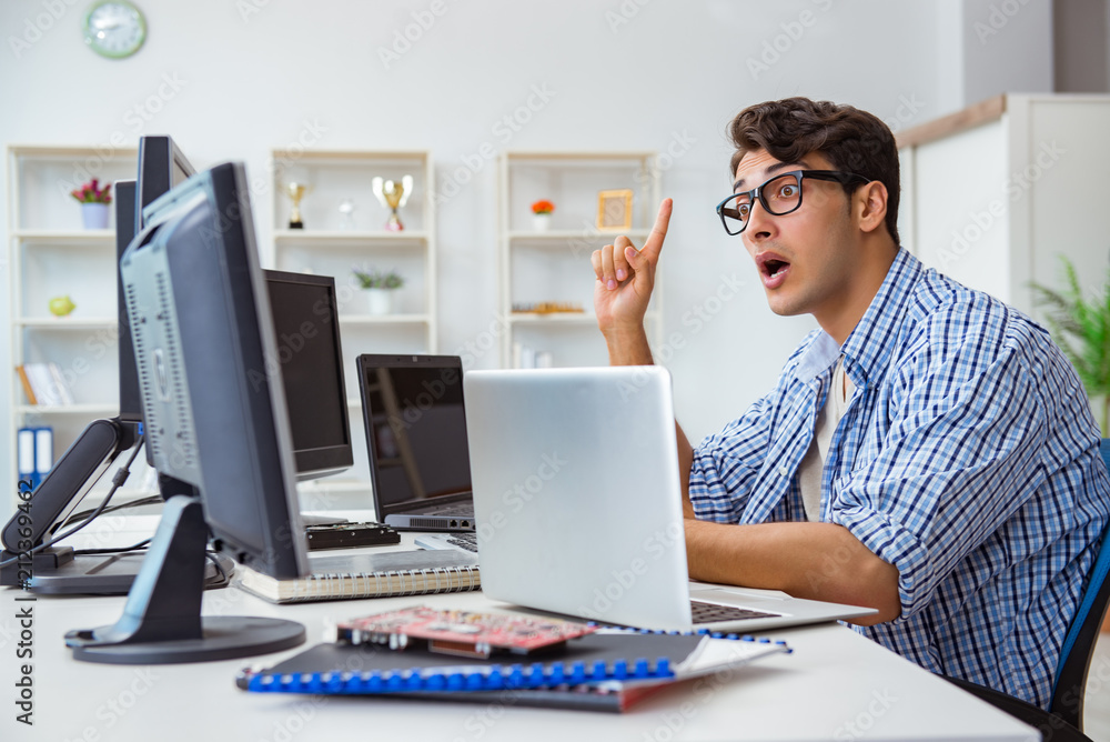 Businessman sitting in front of many screens Businessman sitting in front of many screens