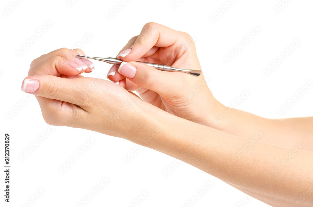 Female hands french manicure pusher on white background isolation Female hands french manicure pusher on white background isolation