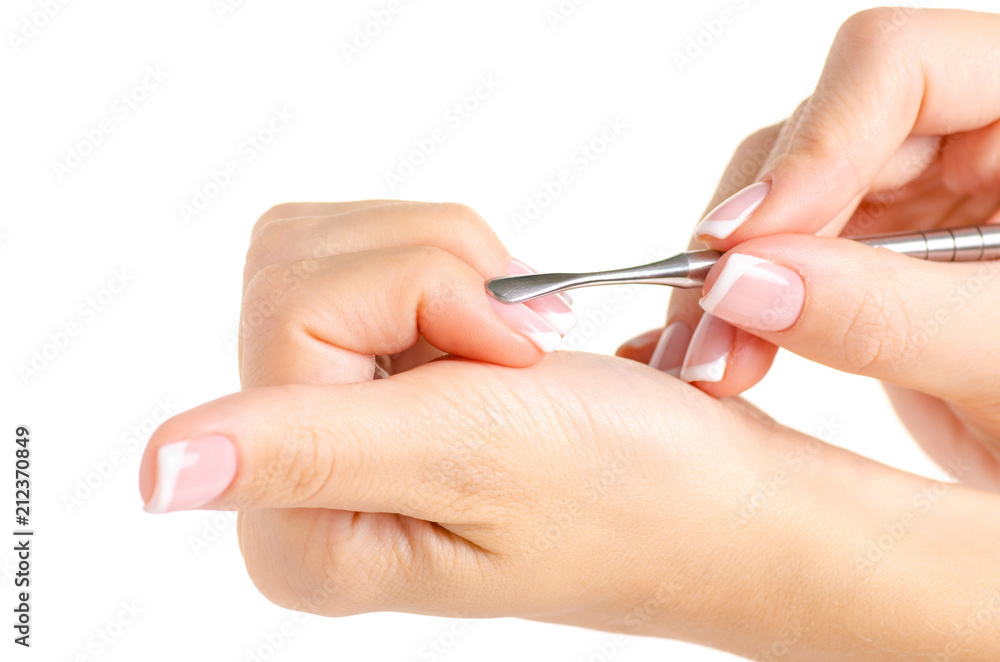 Female hands french manicure pusher on white background isolation