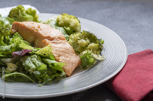 Salmon with cooked broccoli and leafy vegetables