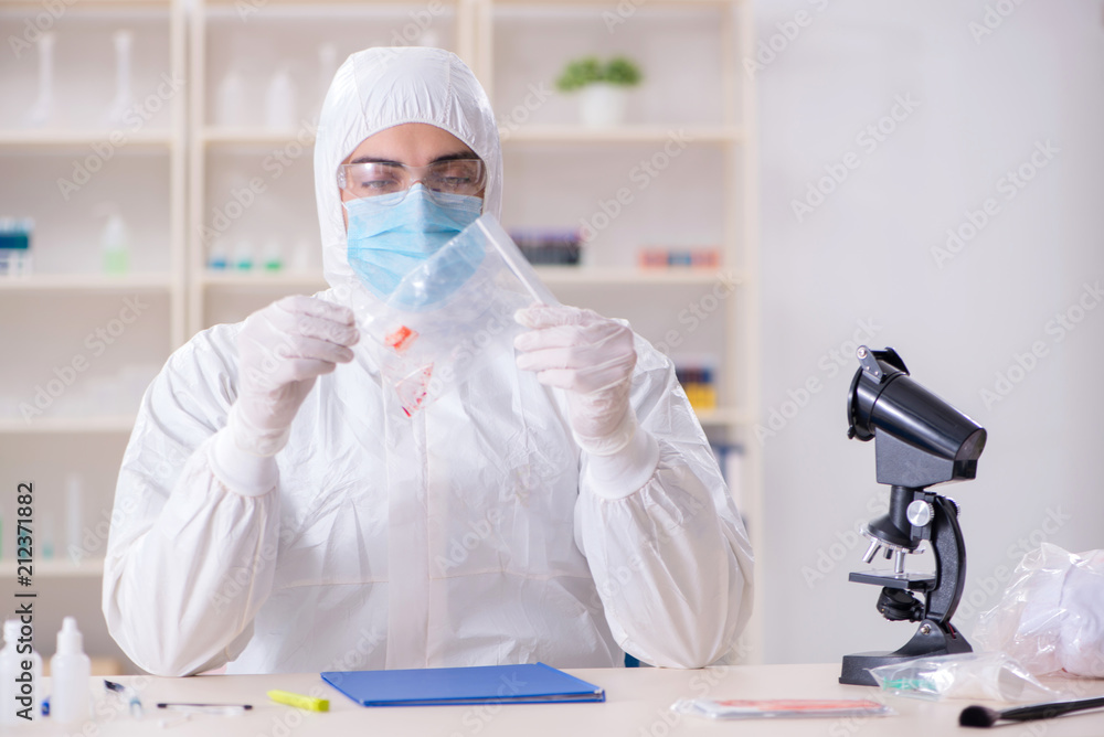 Expert criminologist working in the lab for evidence Expert criminologist working in the lab for evidence