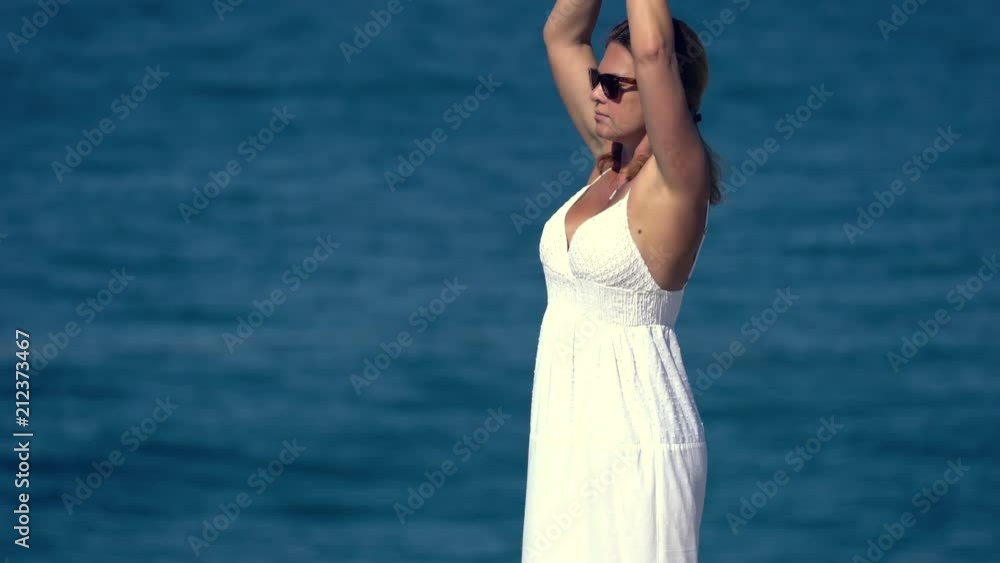 Woman meditating on a cliff over the ocean Woman meditating on a cliff over the ocean