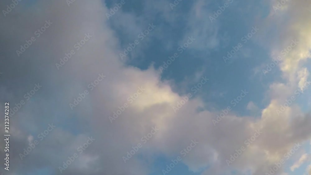 Looking Up to the Moving clouds with blue skies in the background Looking Up to the Moving clouds with blue skies in the background