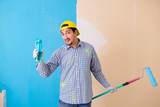 Painter man painting the wall at home