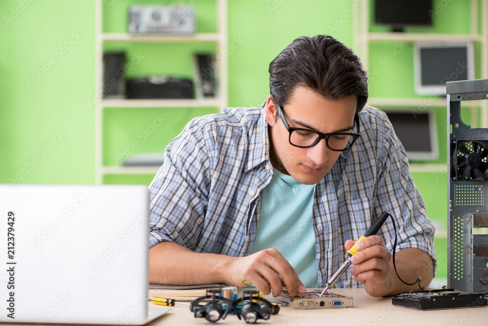 Computer engineer repairing broken desktop Computer engineer repairing broken desktop