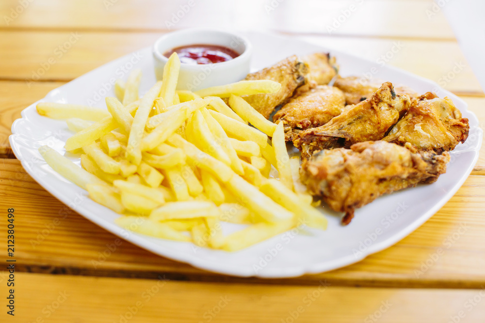 Fried chicken with french fries on the table Fried chicken with french fries on the table