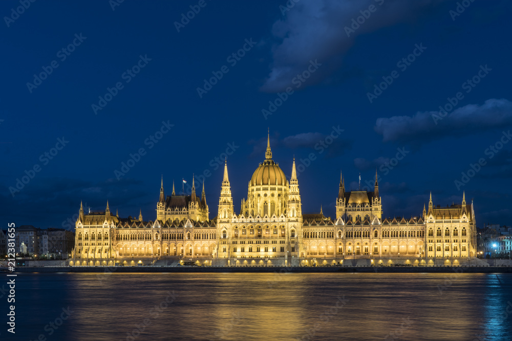 The palace of Parliament in front of Danube river at dusk in Budapest, Hungary