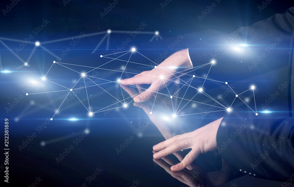 Fototapeta premium Male hands touching interactive table with blue connectivity graphic in the background