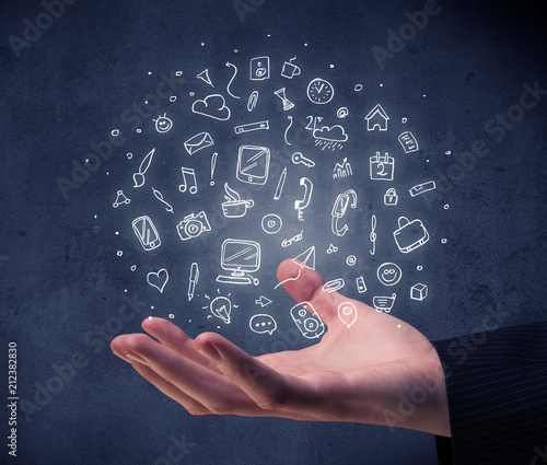 Mixed white media and communication related icons hovering above young hand 