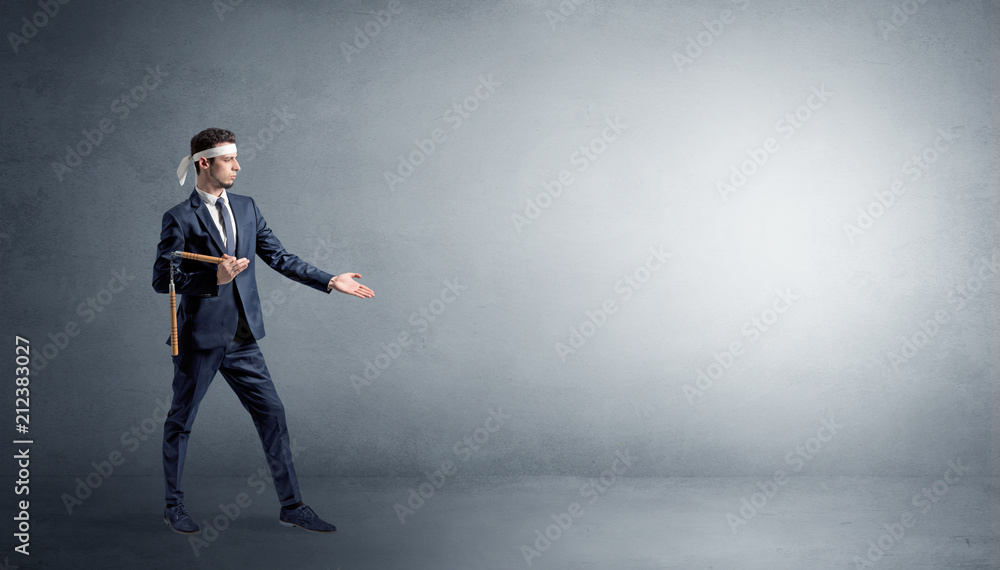 Small karate man fighting in an empty grey copy space Small karate man fighting in an empty grey copy space