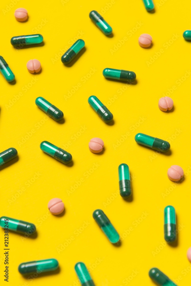 Capsule pills on yellow background. Medical pills. Pharmacy medicaments. Capsule pills on yellow background. Medical pills. Pharmacy medicaments.