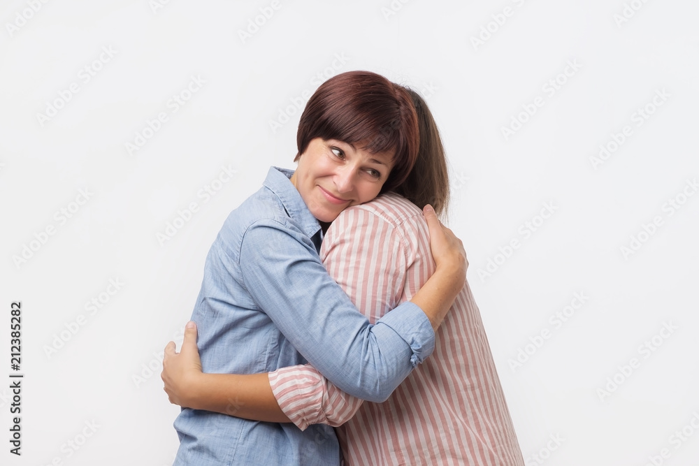 European mother and daughter hugging each other. Good family relations. European mother and daughter hugging each other. Good family relations.