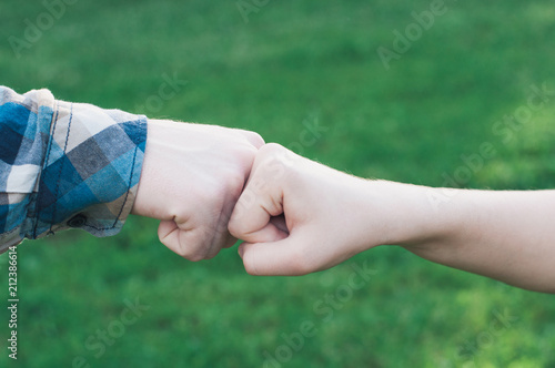 Teenagers giving fist bump at meeting