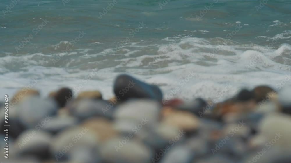 Pebble beach of the sea. the waves on the shore are slow. close up. Pebble beach of the sea. the waves on the shore are slow. close up.