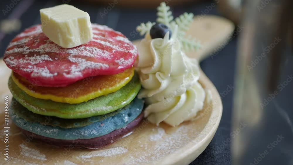 Fresh baked Rainbow Pancake with icing sugar berrie and butter Fresh baked Rainbow Pancake with icing sugar berrie and butter