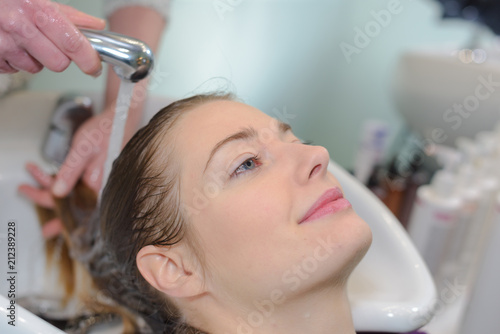 close up of beautiful woman getting a shampoo