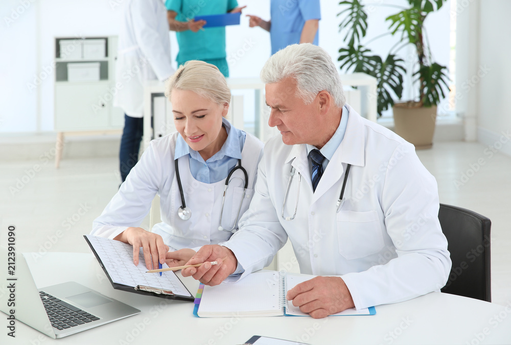 Group of doctors attending meeting in clinic. Cardiology conference