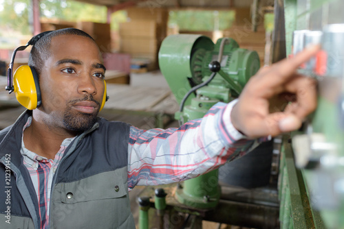 worker adjusting the machine photo